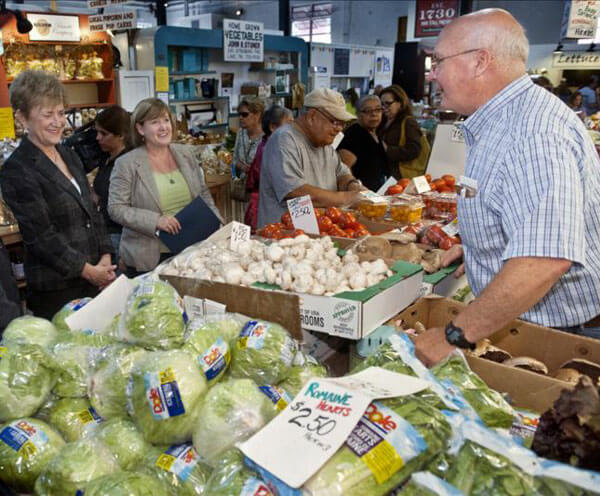 Bob Meck with customers at the Lancaster Central Market.
